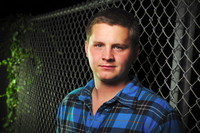 man with chainlink fence